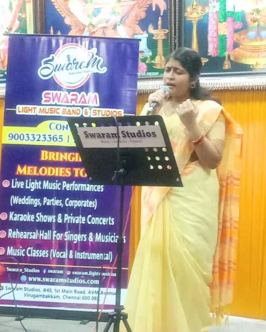 Female singer performing with microphone at live music event