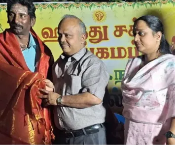 Man being honored with shawl at temple cultural function