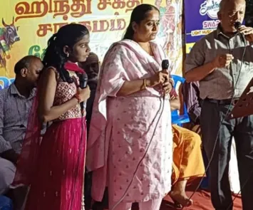 Girl and woman speaking on stage with microphone at event