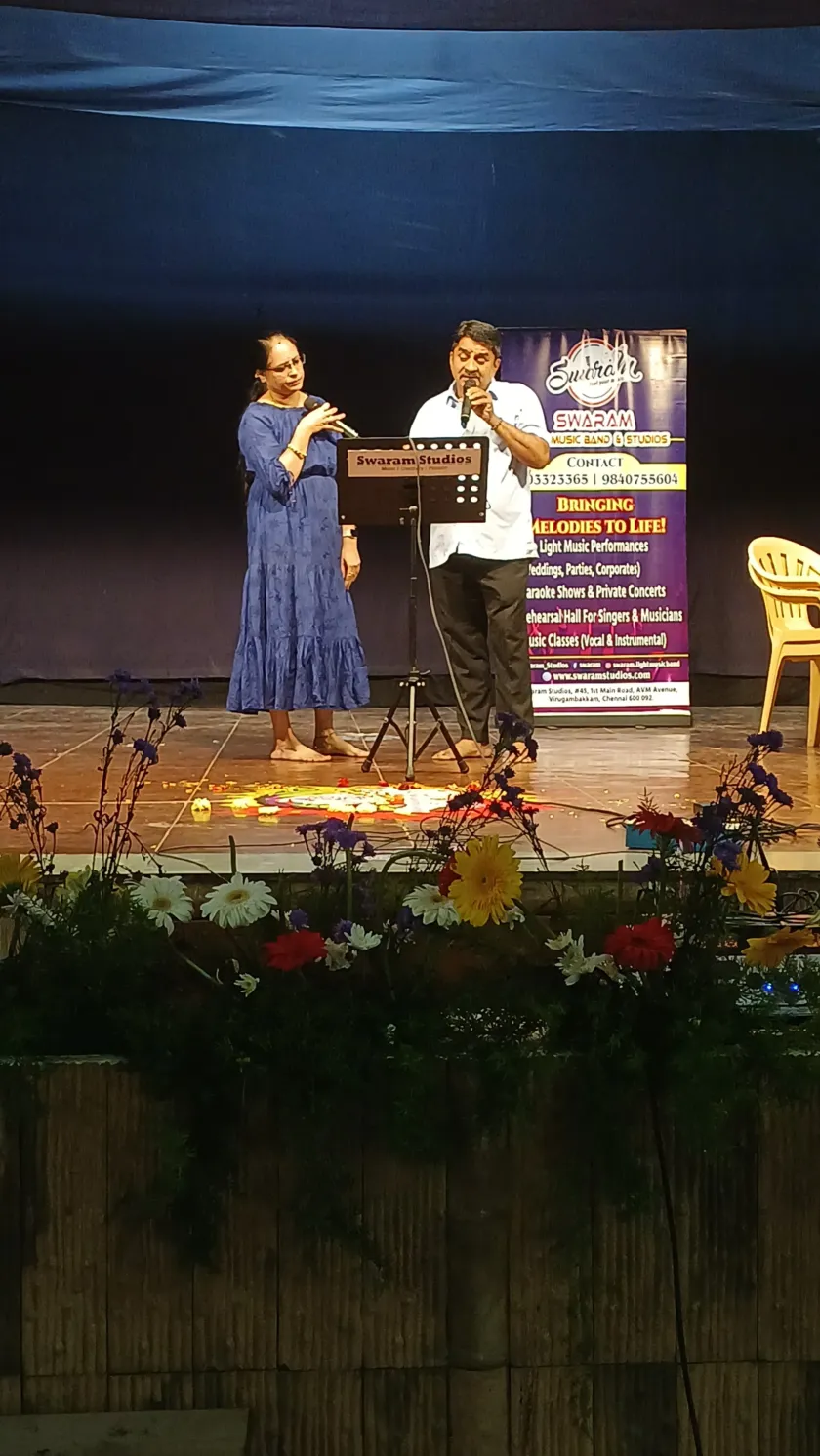 Singers performing on decorated stage with lights