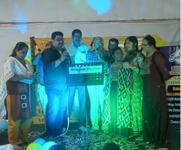 Group singing performance on stage at live music event
