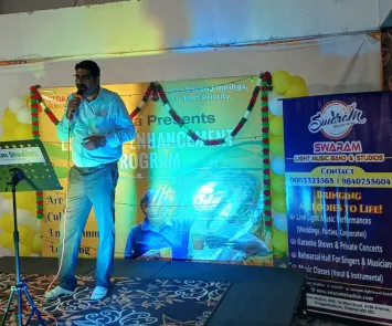 Male singer performing solo on stage with colorful lights