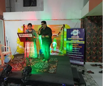 Man and woman singing duet on stage at live music event