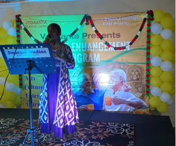 Female singer performing solo on stage with microphone and lights