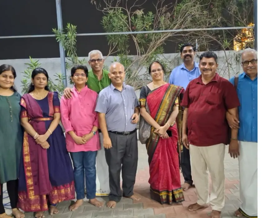 Group photo of families and team at outdoor cultural event