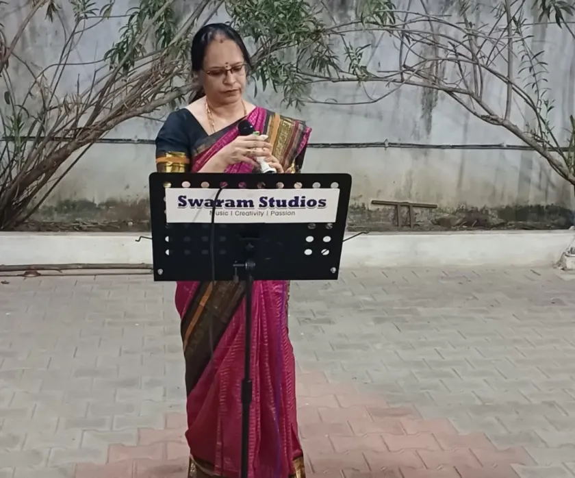 Woman singing outdoor with microphone and music stand