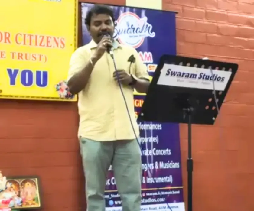 Male singer performing with microphone at live music event