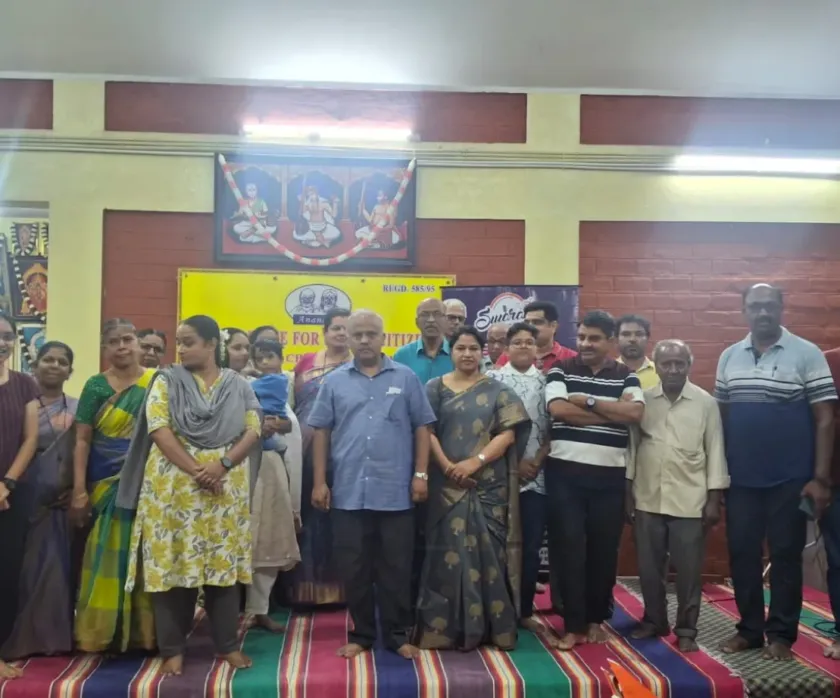 Group photo at indoor cultural event with families and seniors
