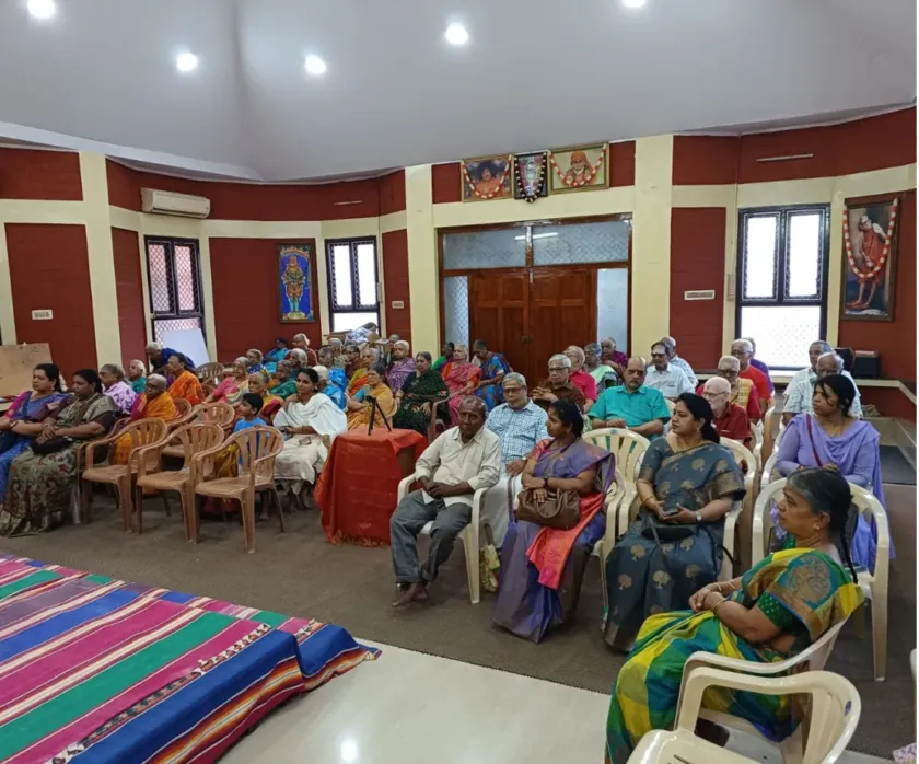 Audience seated inside hall during cultural program