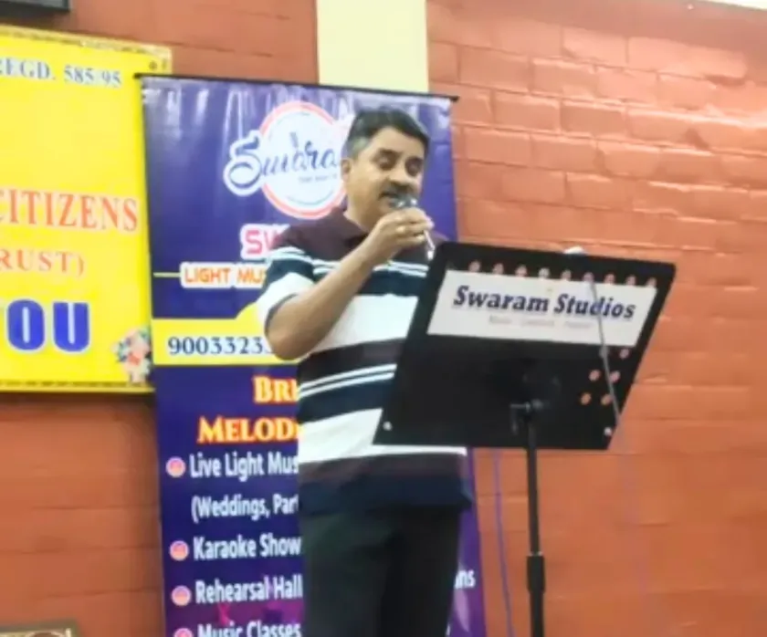Man singing on stage at Swaram Studios event