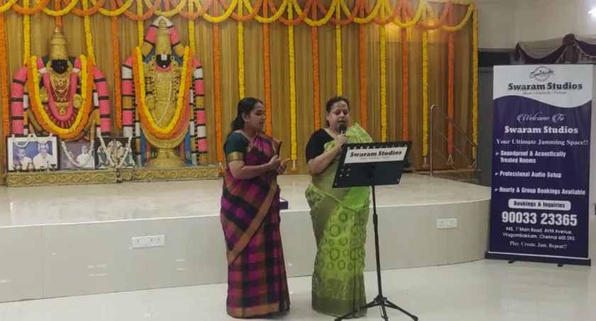 Women singing on stage at temple cultural event
