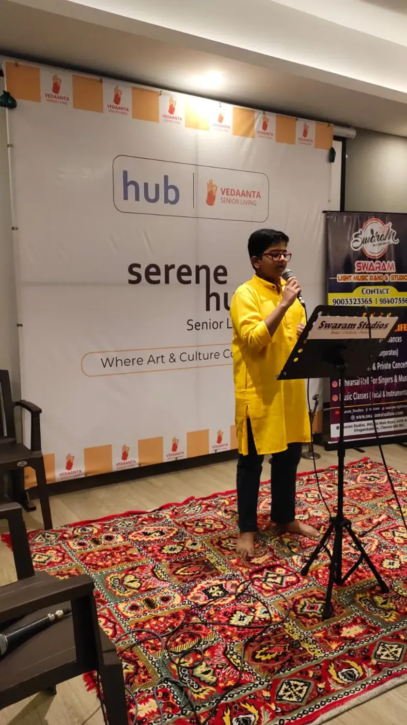 Man speaking on stage at Swaram Studios event