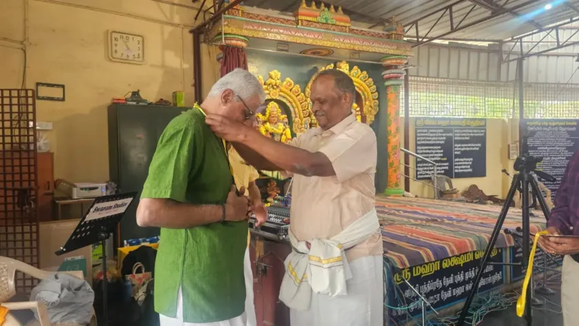 Man receiving shawl honor at temple cultural ceremony