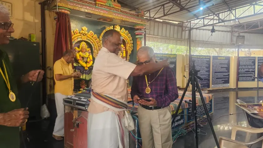 Man being honored with medal at temple event