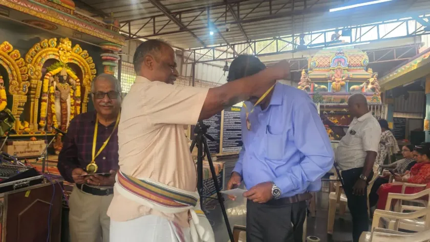 Man receiving shawl and medal at cultural function