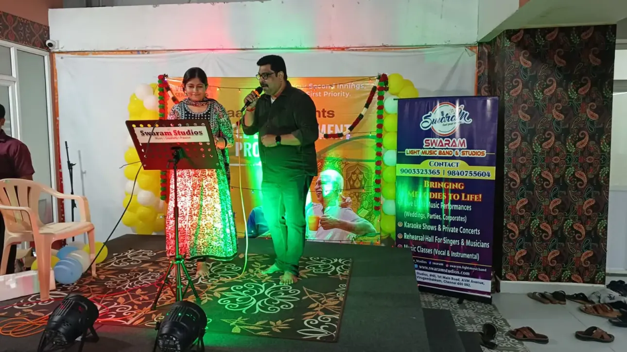 Man and woman singing on stage at music event