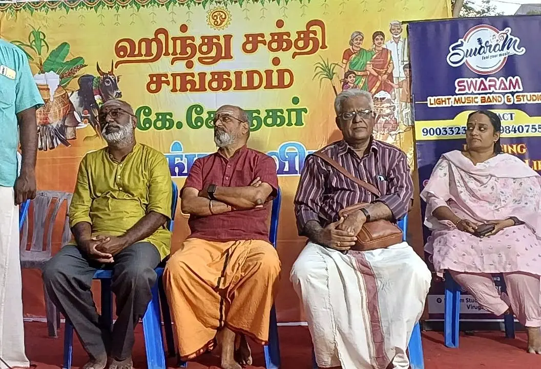 Guests seated on stage at cultural event