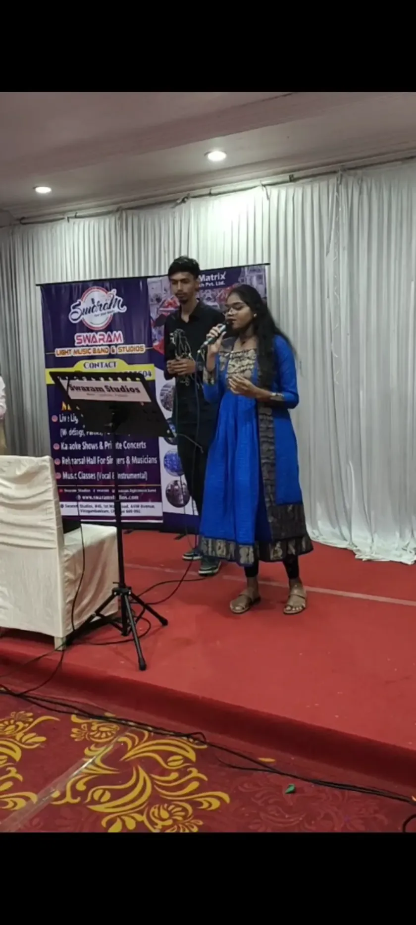 Female singer performing at Swaram Studios event