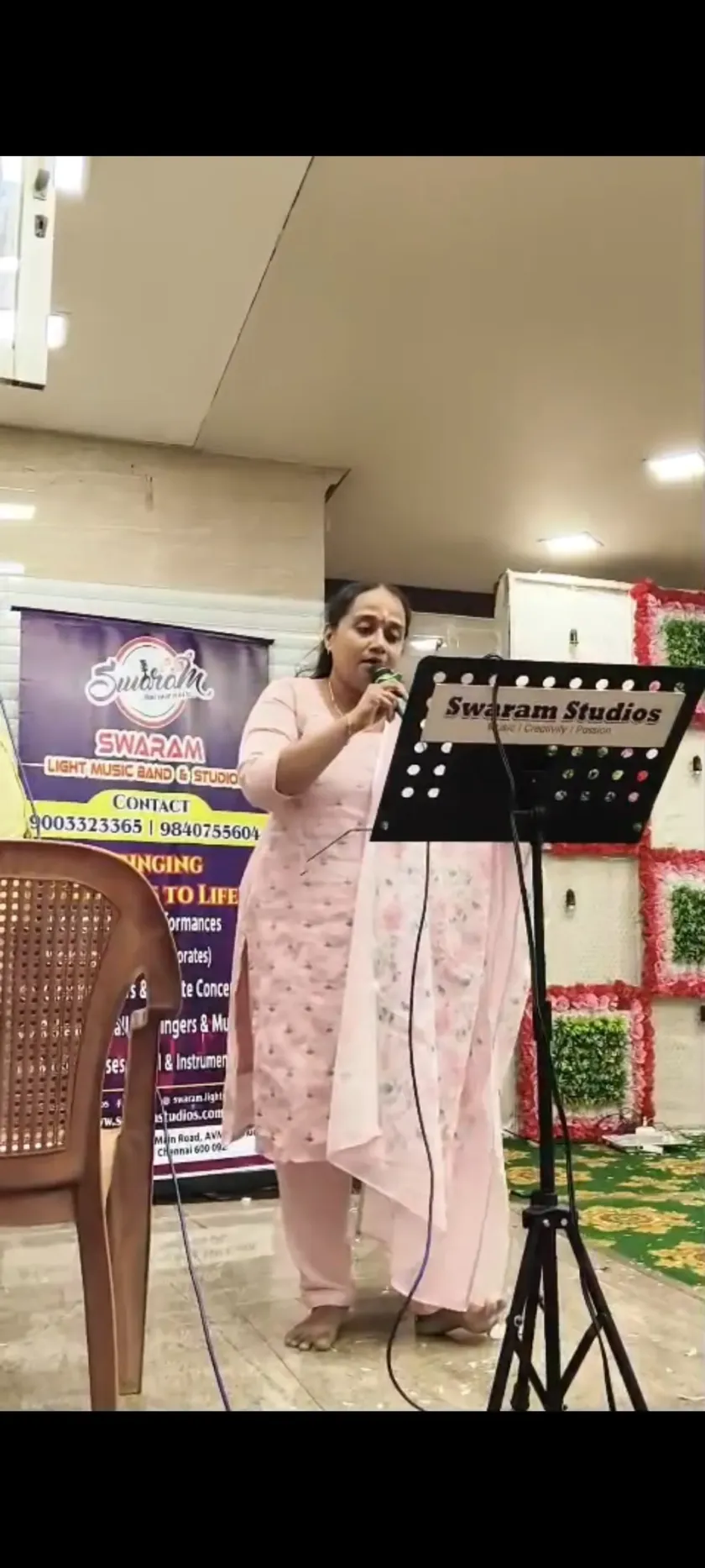 Female singer performing at Swaram Studios event