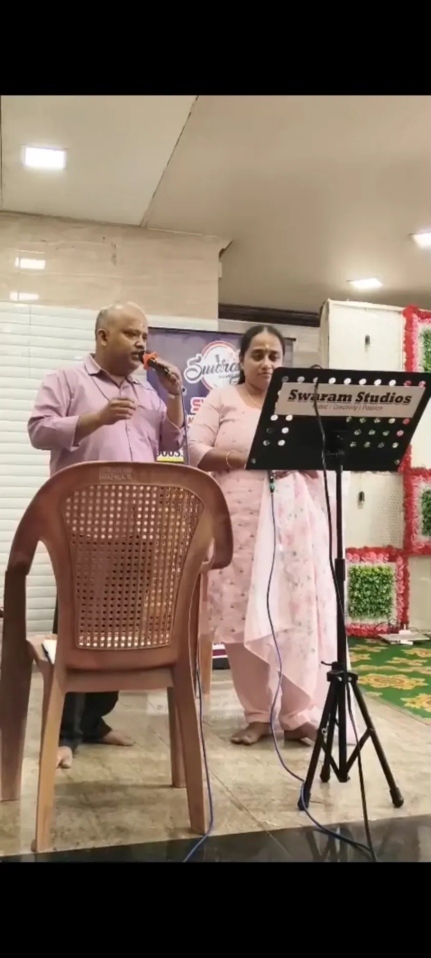 Male and female singers on stage at cultural event