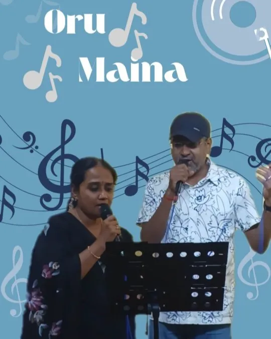 Two male singers performing duet with microphone at studio setup