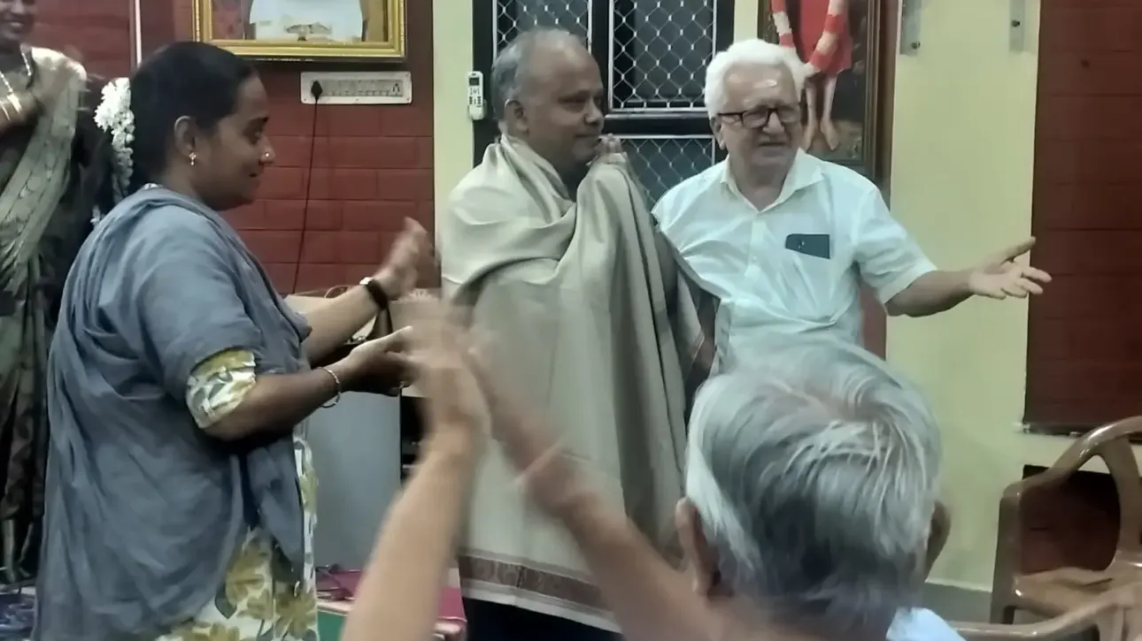 man-honored-with-shawl-indoor-cultural-event
