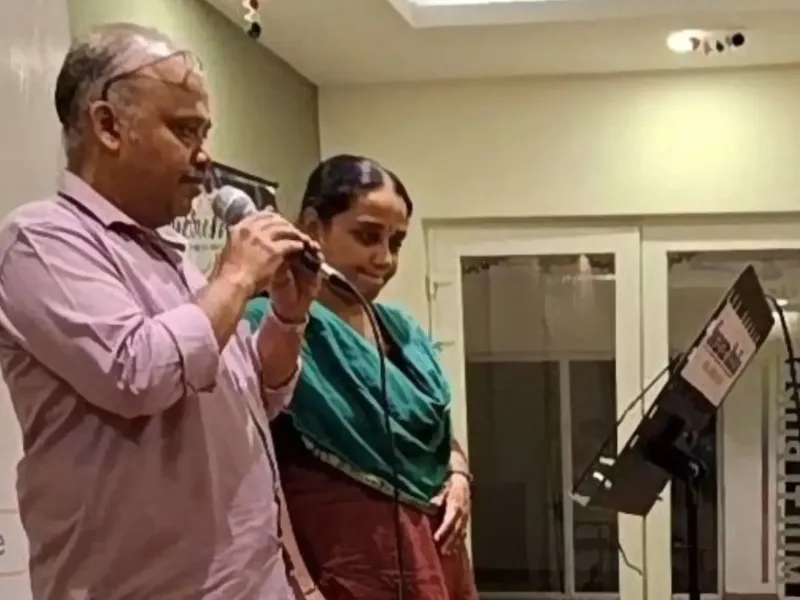 Man and woman speaking with microphone at indoor event