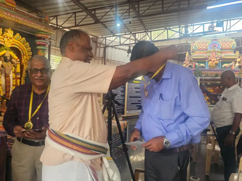 Man receiving honor with shawl at temple event