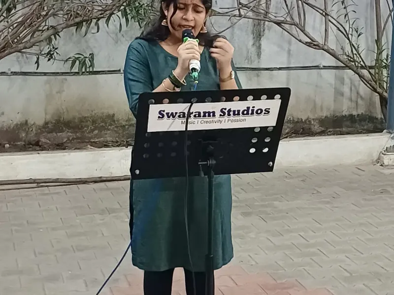 Woman singing with microphone at outdoor event