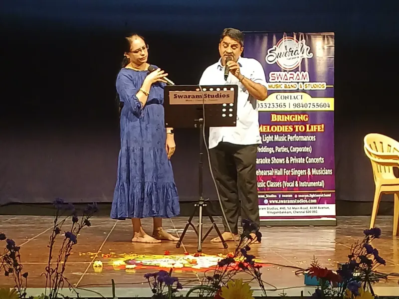 Man and woman singing on stage at live music event